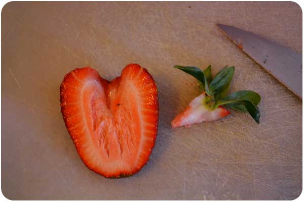 removing the strawberry stem. destemming strawberries